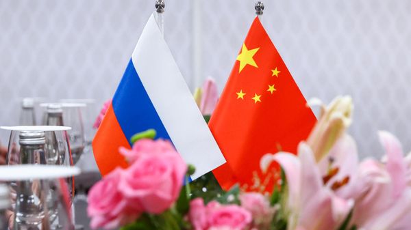 Russian and Chinese flags at the negotiating table during the meeting between Russian Foreign Minister Sergey Lavrov and his Chinese counterpart Qin Gang at the G20 summit in India, March 2, 2023. Russian and Chinese flags at the negotiating table during the meeting between Russian Foreign Minister Sergey Lavrov and his Chinese counterpart Qin Gang at the G20 summit in India, March 2, 2023. - Sputnik International