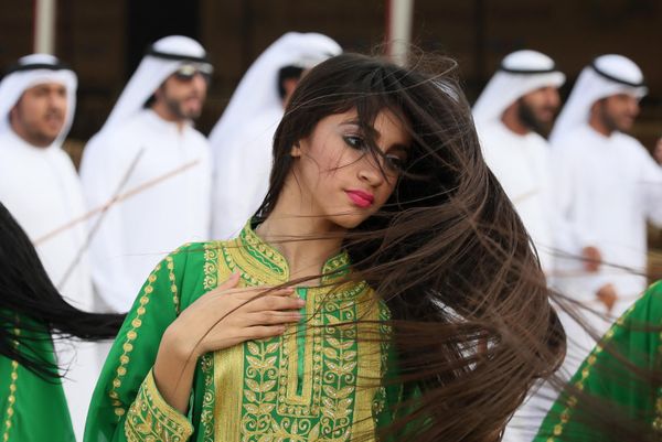 An Emirati woman performs a traditional dance during the camel festival at the Sweihan racecourse, in Al-Ain on the outskirts of Abu Dhabi. - Sputnik International