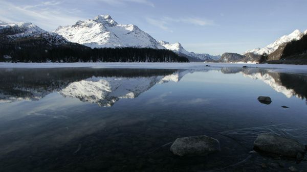 The mountain Piz La Margna is reflected in water and ice of the frozen Lake Sils near the village of Sils Baselgia in the Valley of Engadin, eastern Switzerland, Tuesday, Feb. 20, 2007. The mountain Piz La Margna is reflected in water and ice of the frozen Lake Sils near the village of Sils Baselgia in the Valley of Engadin, eastern Switzerland, Tuesday, Feb. 20, 2007. - Sputnik International
