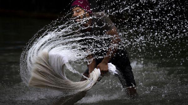 A washerman washes clothes on the banks of the river Brahmaputra on World Water Day in Guwahati, India, Wednesday, March 22, 2023. - Sputnik International