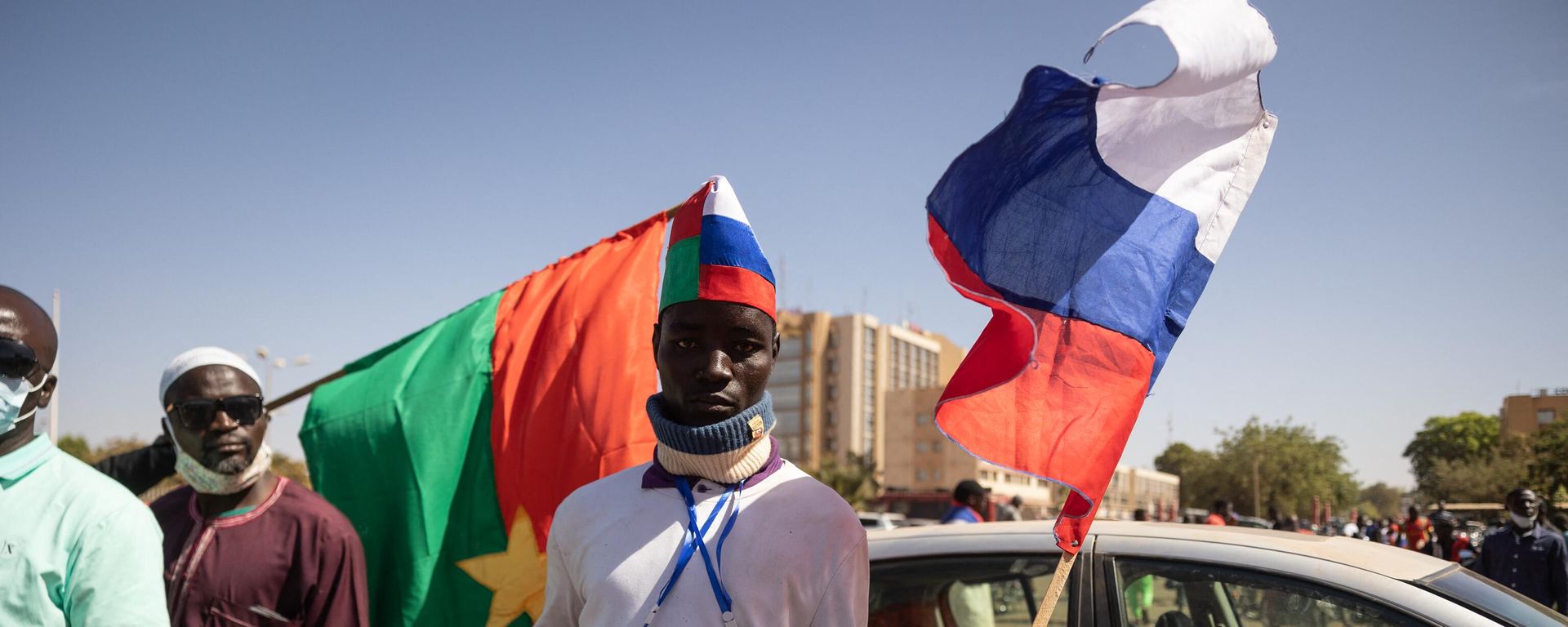 A man holds a Russian flag during a protest to support the Burkina Faso President Captain Ibrahim Traore and to demand the departure of France's ambassador and military forces, in Ouagadougou, on January 20, 2023 - Sputnik International, 1920, 25.03.2023