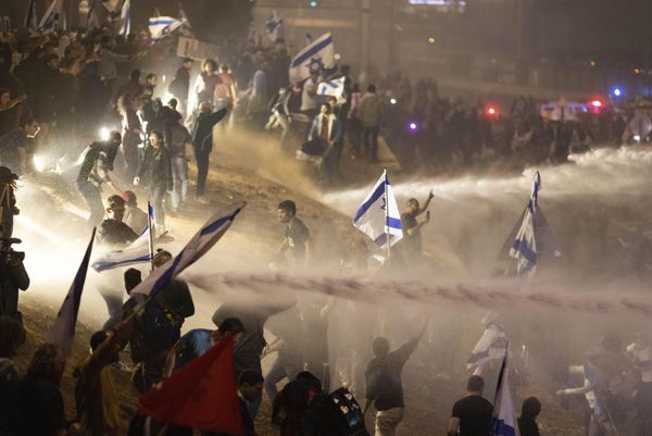 Israeli police use a water cannon to disperse demonstrators blocking a highway during a protest against plans by Prime Minister Benjamin Netanyahu's government to overhaul the judicial system in Tel Aviv, Israel. - Sputnik International