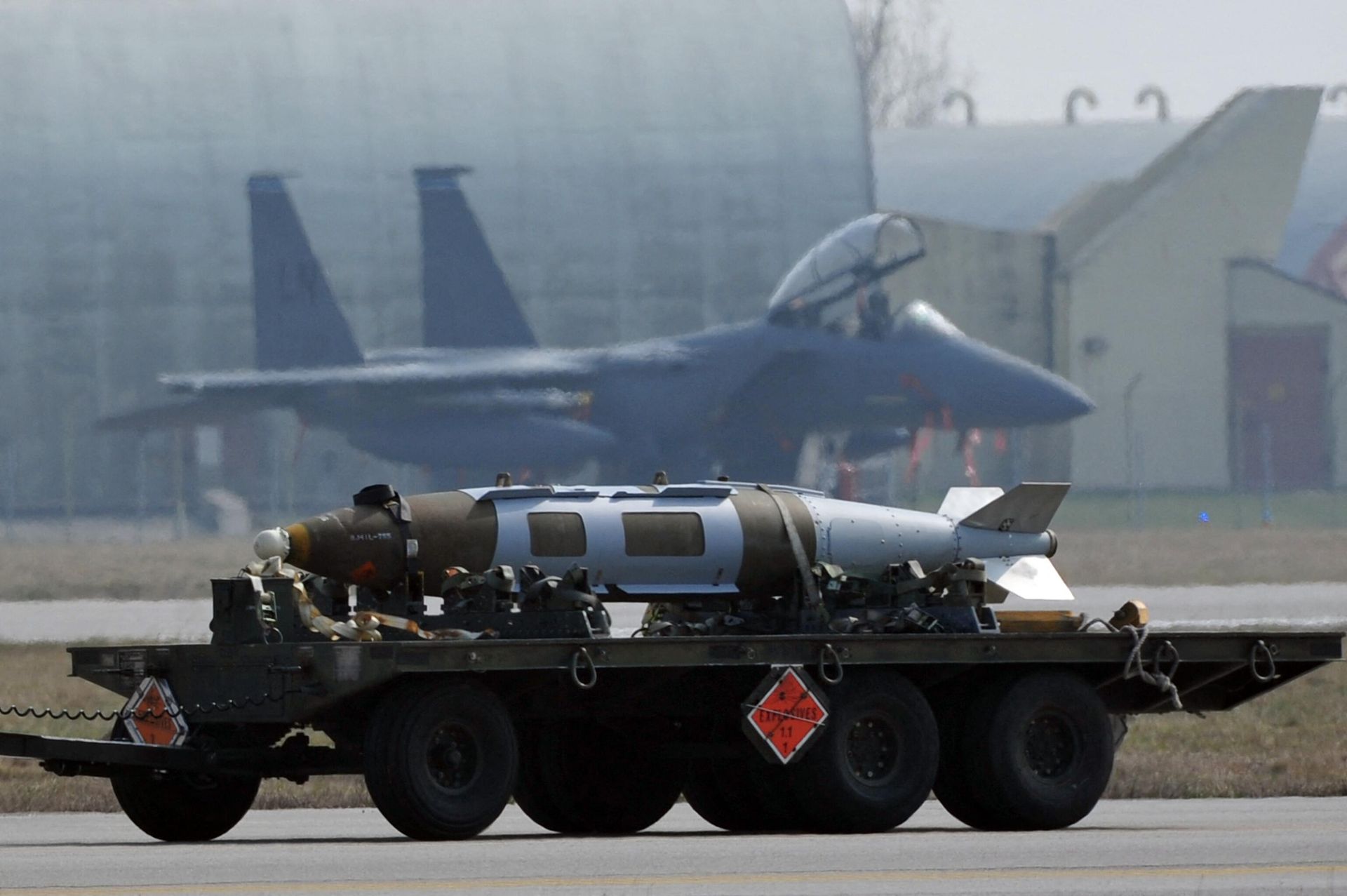 Weapons are carried in front of US airforce F15 jet fighter at the Aviano air base on March 25, 2011. - Sputnik International, 1920, 27.03.2023