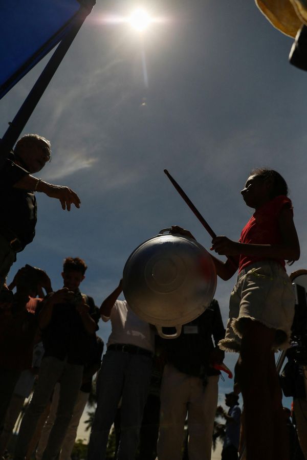 During a hybrid solar eclipse, the Moon's shadow moves across the Earth's surface at supersonic speeds.Above: East Timorese President Jose Ramos-Horta (L) received a pan and a stick, which according to local belief would restore the sun, during the solar eclipse in Dili. - Sputnik International