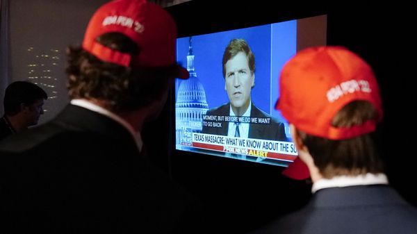 Supporters wait to hear U.S. Senate candidate Herschel Walker speak during an election night watch party as they watch TV host Tucker Carlson, May 24, 2022, in Atlanta - Sputnik International