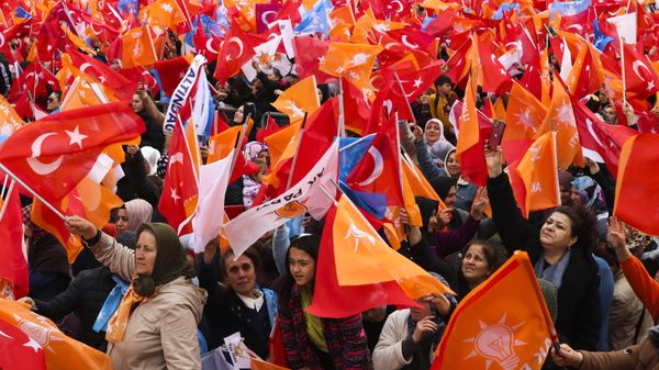 People waves Turkish and AK ruling party flags as they listen to Turkish President and People's Alliance's presidential candidate Recep Tayyip Erdogan during an election campaign rally in Ankara, Sunday, April 30, 2023. Presidential elections in Turkey are scheduled to take place on May 14. - Sputnik International