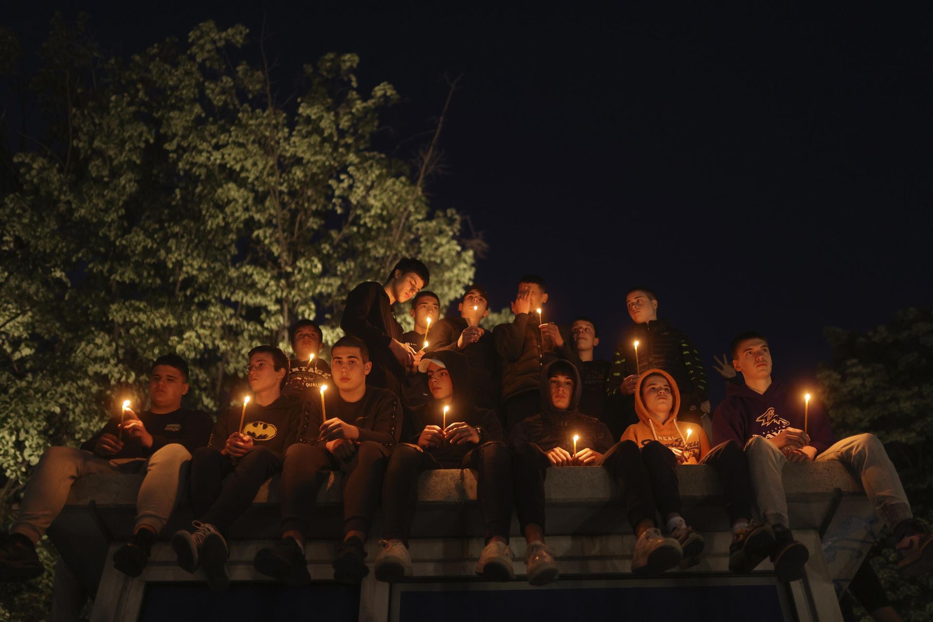 People hold candles for the victims near the Vladislav Ribnikar school in Belgrade, Serbia, Wednesday, May 3, 2023. Police say a 13-year-old who opened fire at his school drew sketches of classrooms and made a list of people he intended to target. He killed eight fellow students and a school guard before being arrested. People hold candles for the victims near the Vladislav Ribnikar school in Belgrade, Serbia, Wednesday, May 3, 2023. Police say a 13-year-old who opened fire at his school drew sketches of classrooms and made a list of people he intended to target. He killed eight fellow students and a school guard before being arrested. - Sputnik International, 1920, 03.05.2023