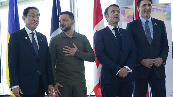 Japanese Prime Minister Fumio Kishida, left, and Ukrainian President Volodymyr Zelenskyy talk as French President Emmanuel Macron, second right, and Canadian Prime Minister Justin Trudeau, right, wait prior to a working session on Ukraine during the G7 Summit in Hiroshima, Japan, Sunday, May 21, 2023.  - Sputnik International