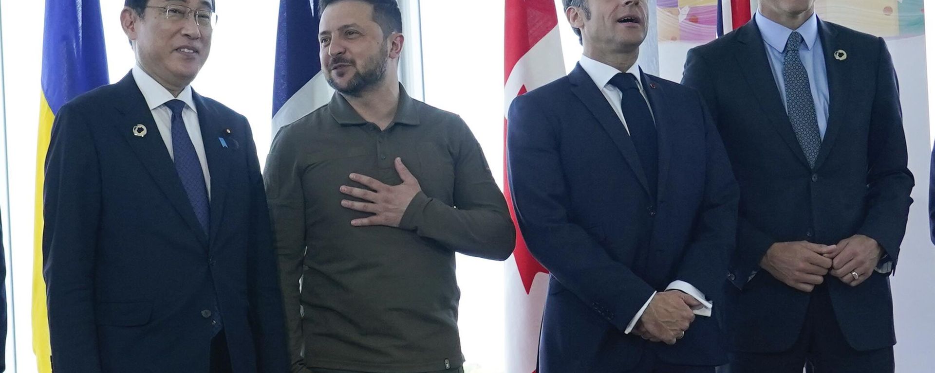 Japanese Prime Minister Fumio Kishida, left, and Ukrainian President Volodymyr Zelenskyy talk as French President Emmanuel Macron, second right, and Canadian Prime Minister Justin Trudeau, right, wait prior to a working session on Ukraine during the G7 Summit in Hiroshima, Japan, Sunday, May 21, 2023.  - Sputnik International, 1920, 10.02.2026