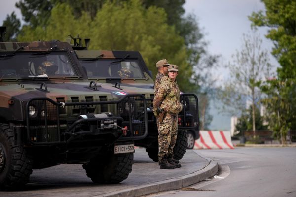 NATO soldiers stand guard in the town of Mitrovica as Serbs protest against the installation of ethnic Albanian mayors. - Sputnik International
