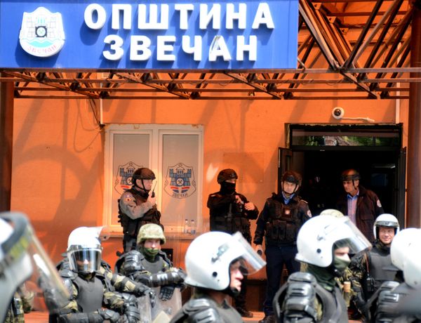Kosovo riot police along with KFOR military police secure access to a municipal building in Zvecan as Kosovo Serbs gather outside the building after police helped install ethnic Albanian mayors following controversial elections. Police fired tear gas during clashes with ethnic Serbs protesting to demand the withdrawal of law enforcement officers from northern Kosovo along with new ethnic Albanian mayors. - Sputnik International