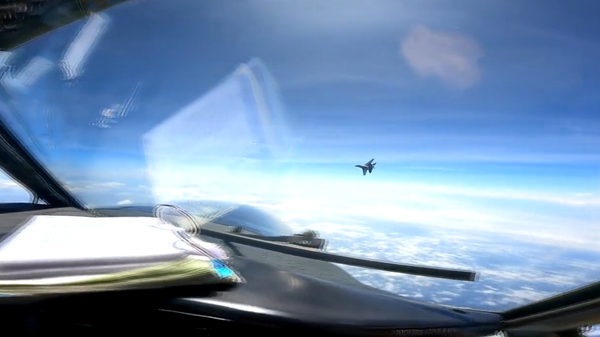 Chinese fighter jet intercepts US spy plane operating over the South China Sea. Screengrab from US Indo-Pacific Command video. - Sputnik International