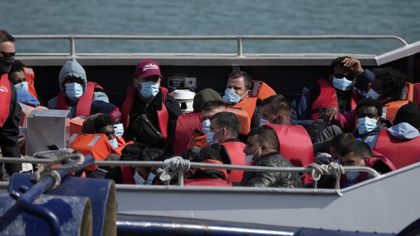 People thought to be migrants who undertook the crossing from France in small boats and were picked up in the Channel, wait to be disembarked from a British border force vessel, in Dover, south east England - Sputnik International