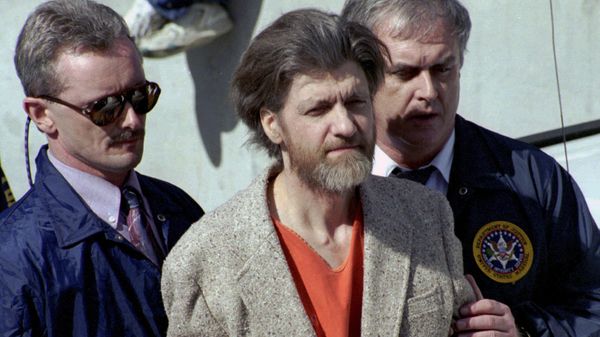 Theodore Ted Kaczynski is flanked by federal agents as he is led to a car from the federal courthouse in Helena, Mont., April 4, 1996. - Sputnik International