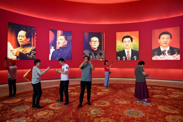 A group of people take pictures in front of portraits of (L to R) late Chinese Communist Party Chairman Mao Zedong and former Chinese leaders Deng Xiaoping, Jiang Zemin, Hu Jintao, and current President Xi Jinping at an exhibition marking the country's achievements over the past 70 years, ahead of the 70th anniversary of the founding of the People's Republic of China, in Beijing. - Sputnik International