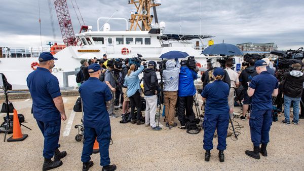 Members of the Coast Guard watch as US Coast Guard Captain Jamie Frederick speaks during a press conference about the search efforts for the submersible that went missing near the wreck of the Titanic, at Coast Guard Base in Boston, Massachusetts, on June 20, 2023. - Sputnik International
