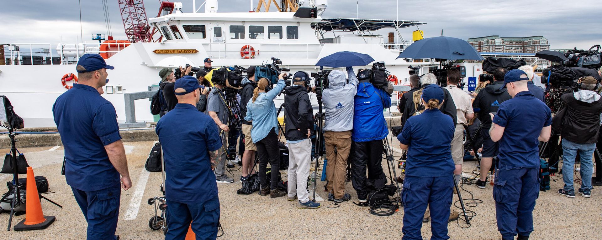 Members of the Coast Guard watch as US Coast Guard Captain Jamie Frederick speaks during a press conference about the search efforts for the submersible that went missing near the wreck of the Titanic, at Coast Guard Base in Boston, Massachusetts, on June 20, 2023. - Sputnik International, 1920, 21.06.2023