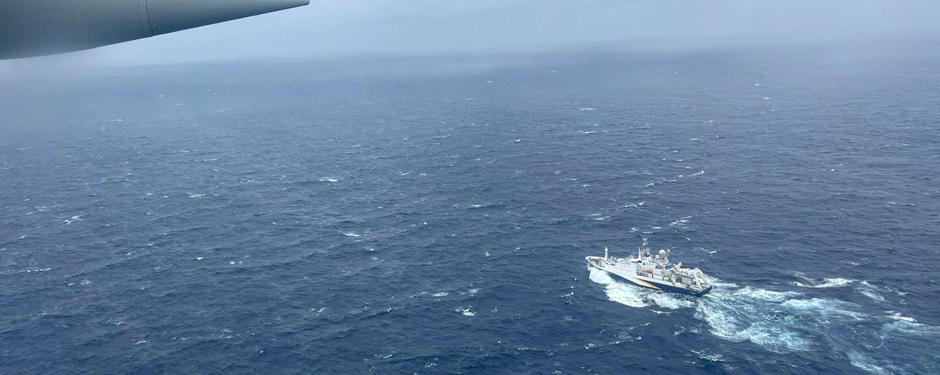 In this image provided by the U.S. Coast Guard, a Coast Guard HC-130 Hercules airplane based at Coast Guard Air Station Elizabeth City, N.C., flies over the French research vessel, L'Atalante approximately 900 miles East of Cape Cod, Mass., during the search for the 21-foot submersible, Titan, Wednesday, June 21, 2023. In this image provided by the U.S. Coast Guard, a Coast Guard HC-130 Hercules airplane based at Coast Guard Air Station Elizabeth City, N.C., flies over the French research vessel, L'Atalante approximately 900 miles East of Cape Cod, Mass., during the search for the 21-foot submersible, Titan, Wednesday, June 21, 2023. - Sputnik International, 1920, 22.06.2023