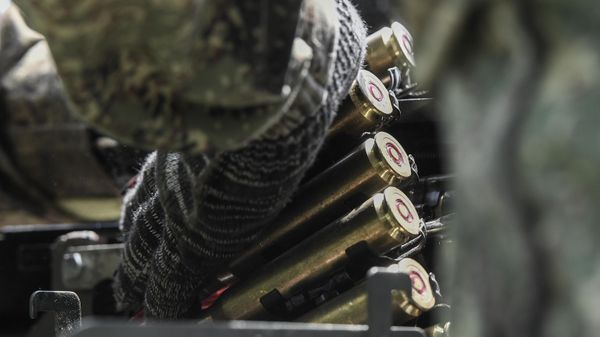 A Russian serviceman of a mobile anti-aircraft unit loads ammunition for a DShK machine gun on the back a UAZ truck as he is on combat duty for repelling attacks of Ukrainian unmanned aerial vehicles in the course of Russia's military operation in Ukraine  - Sputnik International