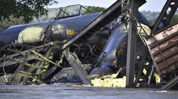Several train cars are immersed in the Yellowstone River after a bridge collapse near Columbus, Mont., on Saturday, June 24, 2023. The bridge collapsed overnight, causing a train that was traveling over it to plunge into the water below. Authorities on Sunday were testing the water quality along a stretch of the Yellowstone River where mangled cars carrying hazardous materials remained after crashing into the waterway.  - Sputnik International
