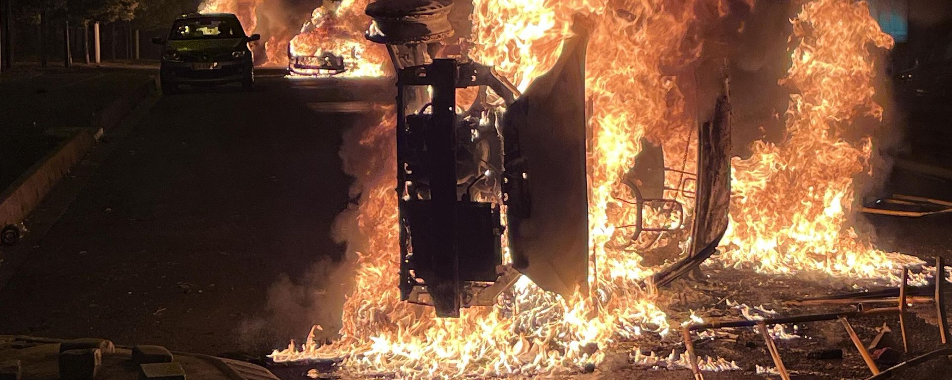 Burning vehicles are seen during clashes between protesters and police, after the death of Nahel, a 17-year-old teenager killed by a French police officer during a traffic stop, in Nanterre, Paris suburb, France. Burning vehicles are seen during clashes between protesters and police, after the death of Nahel, a 17-year-old teenager killed by a French police officer during a traffic stop, in Nanterre, Paris suburb, France. - Sputnik International, 1920, 29.06.2023