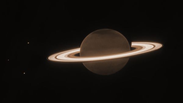 This June 2023 image provided by the Space Telescope Science Institute shows the planet Saturn and three of its moons, from left, Enceladus, Tethys and Dione, captured by the James Webb Space Telescope. - Sputnik International