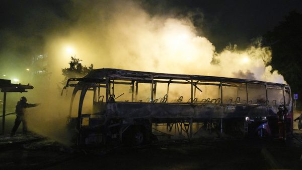 A firefighter uses a water hose on a burnt bus in Nanterre, outside Paris, France, Saturday, July 1, 2023.  - Sputnik International