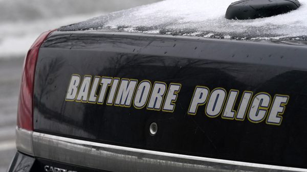 A Baltimore police cruiser is seen outside of a building as officers check on a call, Thursday, Feb. 18, 2021, in Baltimore. - Sputnik International