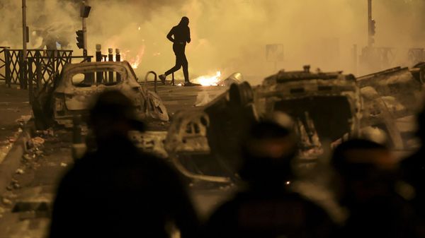 A demonstrator runs on the third night of protests sparked by the fatal police shooting of a 17-year-old driver in the Paris suburb of Nanterre, France, Friday, June 30, 2023. After six years in power, French President Emmanuel Macron appears further weakened by days of rioting over the death of a teen killed by police that come on top of a series of other challenges at home, leading domestic politics to impede his influence abroad. Macron was forced to delay his state visit to Germany meant to show the strength of the friendship between both nations after recent disputes over on issues including energy, defense and the economy.  - Sputnik International