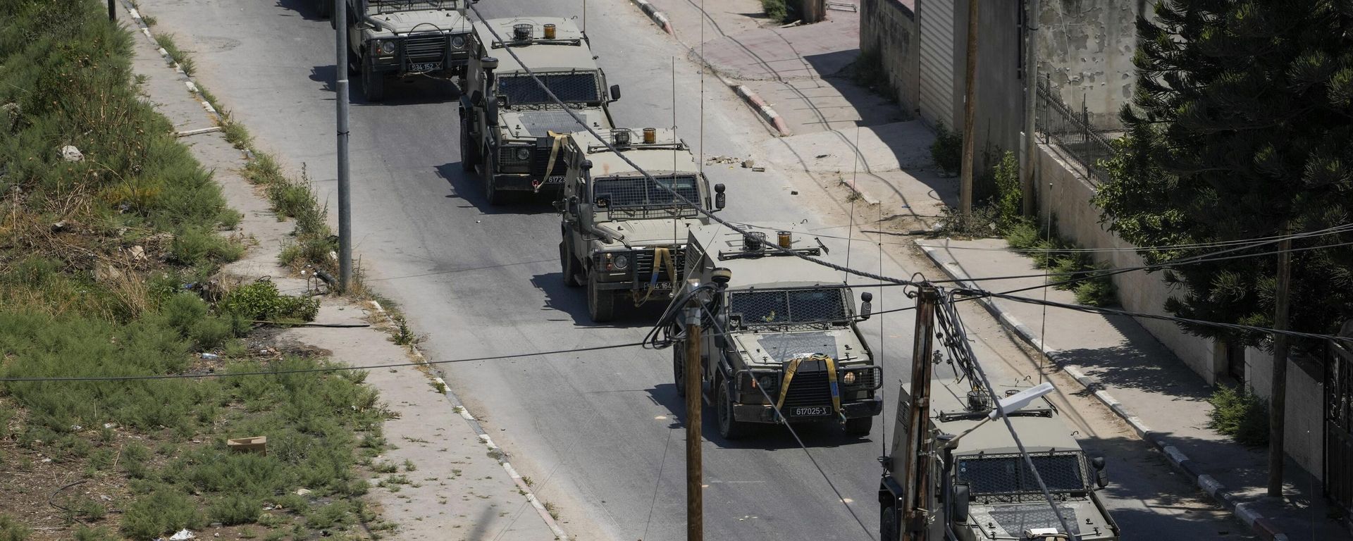 A convoy of army vehicles is seen during an Israeli military raid on the militant stronghold of the Jenin refugee camp in the occupied West Bank, Monday, July 3, 2023. Israeli drones struck targets and deployed hundreds of troops in the area in the largest operation in the area in more than a year of fighting. Palestinian health officials said at least eight Palestinians were killed. A convoy of army vehicles is seen during an Israeli military raid on the militant stronghold of the Jenin refugee camp in the occupied West Bank, Monday, July 3, 2023. Israeli drones struck targets and deployed hundreds of troops in the area in the largest operation in the area in more than a year of fighting. Palestinian health officials said at least eight Palestinians were killed. - Sputnik International, 1920, 13.12.2023