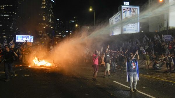 Israeli police use a water cannon to disperse demonstrators blocking the freeway during protest against plans by Prime Minister Benjamin Netanyahu's government to overhaul the judicial system in Tel Aviv, Israel, Wednesday, July 5, 2023 - Sputnik International
