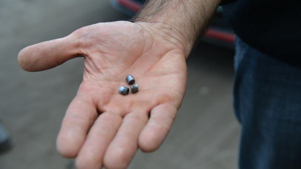 A man demonstrates fragments of cluster munition that were used to shell Kupyansk - Sputnik International