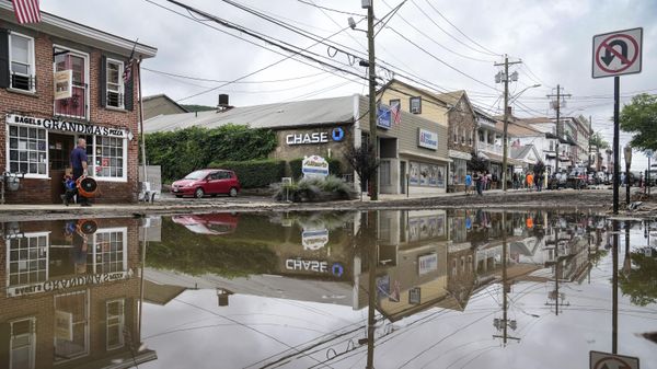 Residents, journalists, and emergency service workers walk around a flooded Main Street, Monday, July 10, 2023, in Highland Falls, N.Y. Heavy rain has washed out roads and forced evacuations in the Northeast as more downpours were forecast throughout the day. One person in New York's Hudson Valley has drowned as she was trying to leave her home. - Sputnik International