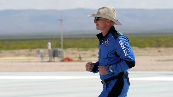 Jeff Bezos, founder of Amazon and space tourism company Blue Origin jogs onto the Blue Origin's New Shepard rocket landing pad to pose for photos at the spaceport near Van Horn, Texas, Tuesday, July 20, 2021.  - Sputnik International