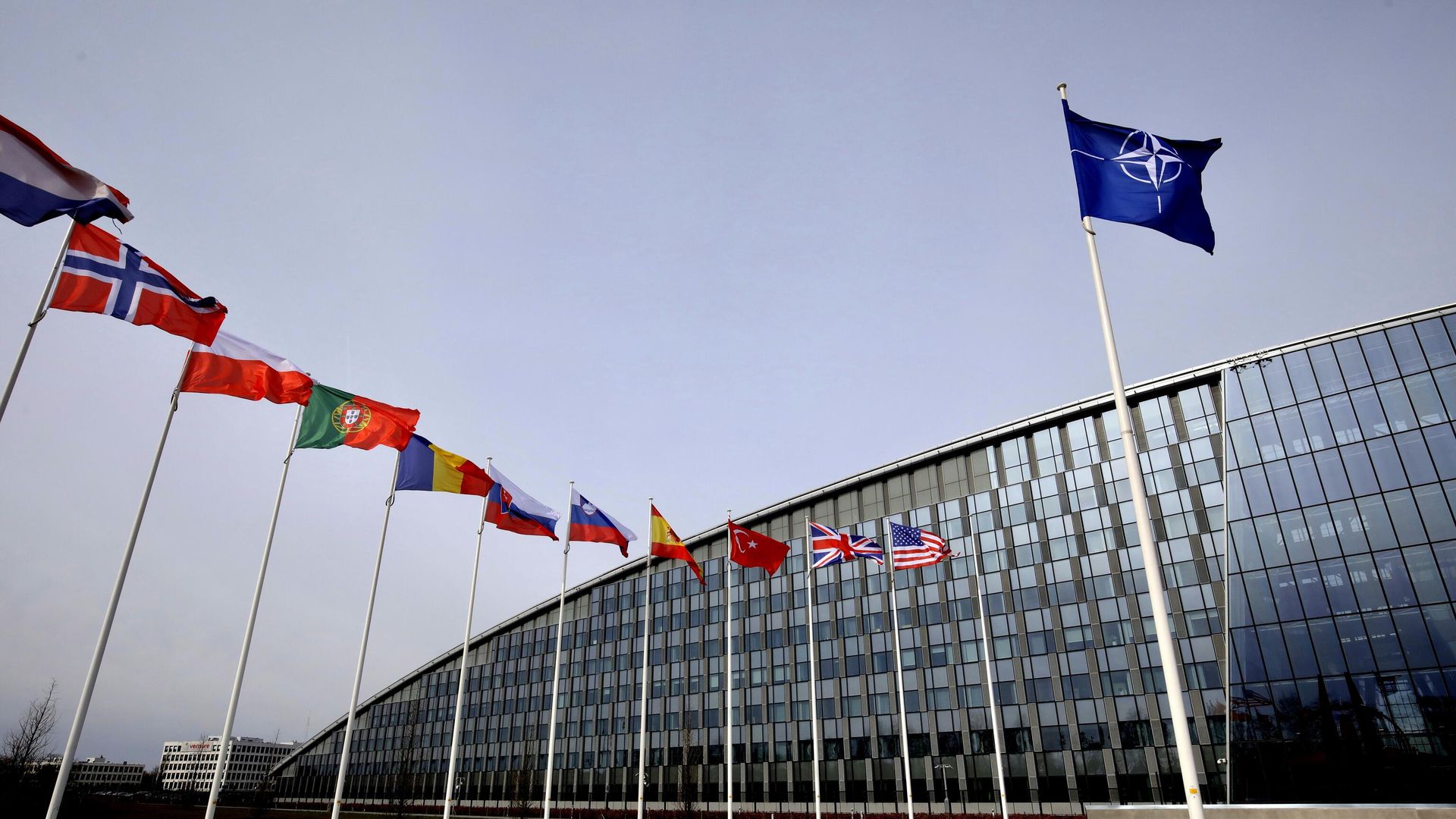 Flags of Alliance members flap in the wind outside NATO headquarters in Brussels, Friday, Feb. 28, 2020. (AP Photo/Olivier Matthys) Flags of Alliance members flap in the wind outside NATO headquarters in Brussels, Friday, Feb. 28, 2020. (AP Photo/Olivier Matthys) - Sputnik International, 1920, 30.11.2023