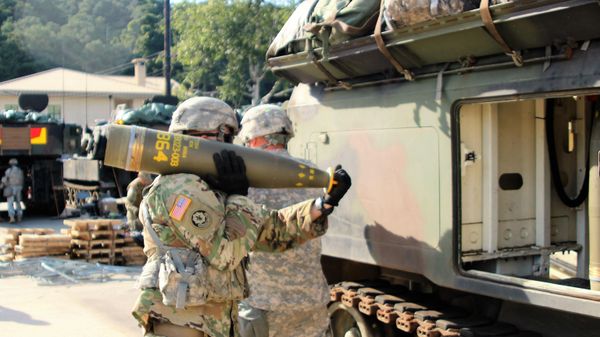 Soldiers from Alpha Battery, 1st Battalion, 82nd Field Artillery Regiment, 1st Armored Brigade Combat Team, 1st Cavalry Division, participate in a load exercise directed by the 210th Field Artillery Brigade, 2nd Infantry Division Sept. 20. They transported and loaded nearly 100 rounds during the exercise. Pictured: A Soldier carries a 155mm Base Burn Dual Purpose Improved Conventional Munition round, weighing more than 100 pounds, to a M992 Field Artillery Support Vehicle during the exercise. - Sputnik International