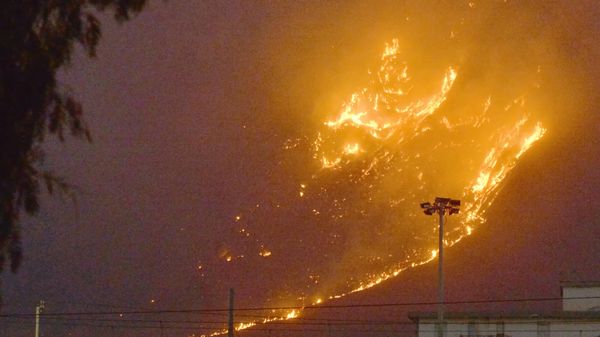 This photo obtained from Italian news agency Ansa shows a vast fire spreading on hills in the area of Monte Grifone and the town of Ciaculli around Palermo, Sicily, on July 25, 2023, with flames threatening nearby houses. Sicilian firefighters were fighting overnight against several fires, one of which neared Palermo airport, forcing it to close for several hours in the morning. - Sputnik International