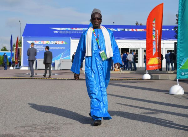 A guest strolls across the grounds of the Russia-Africa Summit and Forum in St. Petersburg. - Sputnik International