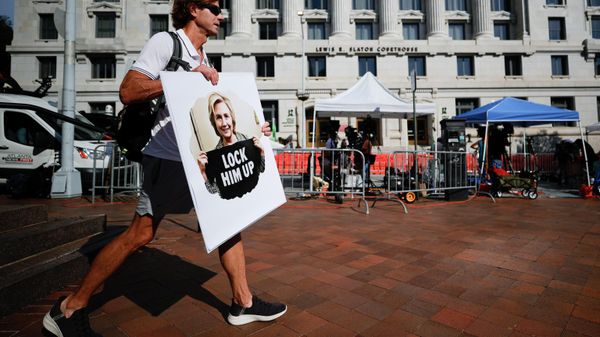 A person holding a sign that reads Lock Him Up, stands outside of the Fulton County Courthouse, Monday, Aug. 14, 2023, in Atlanta. Court officials in Atlanta published a list of criminal charges against former President Donald Trump. But as a Fulton County grand jury began hearing from witnesses Monday, there was no public indication that Trump had been indicted in a long-running investigation of the 2020 presidential election. The list was later deleted.  - Sputnik International