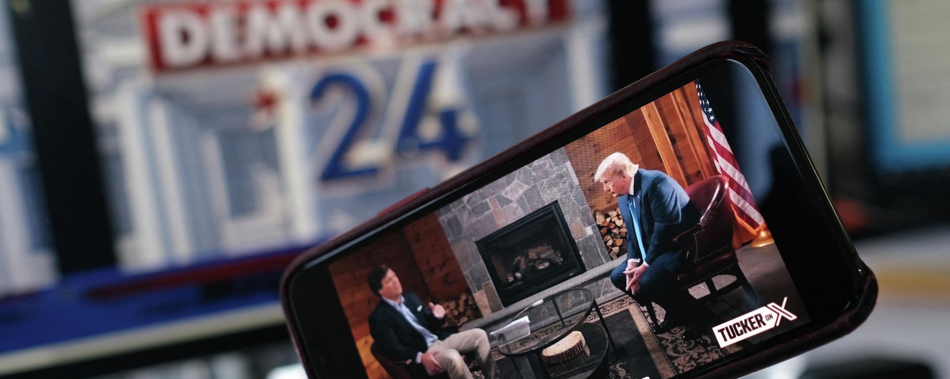 This illustration photo shows a preview of Tucker Carlson's interview of former US President Donald Trump scheduled to air on X (formerly Twitter) on the same night of the first Republican Presidential primary debate in Milwaukee, Wisconsin, on a smartphone ahead of the debate on August 23, 2023. (Photo by Chris DELMAS / AFP) This illustration photo shows a preview of Tucker Carlson's interview of former US President Donald Trump scheduled to air on X (formerly Twitter) on the same night of the first Republican Presidential primary debate in Milwaukee, Wisconsin, on a smartphone ahead of the debate on August 23, 2023. (Photo by Chris DELMAS / AFP) - Sputnik International, 1920, 24.08.2023