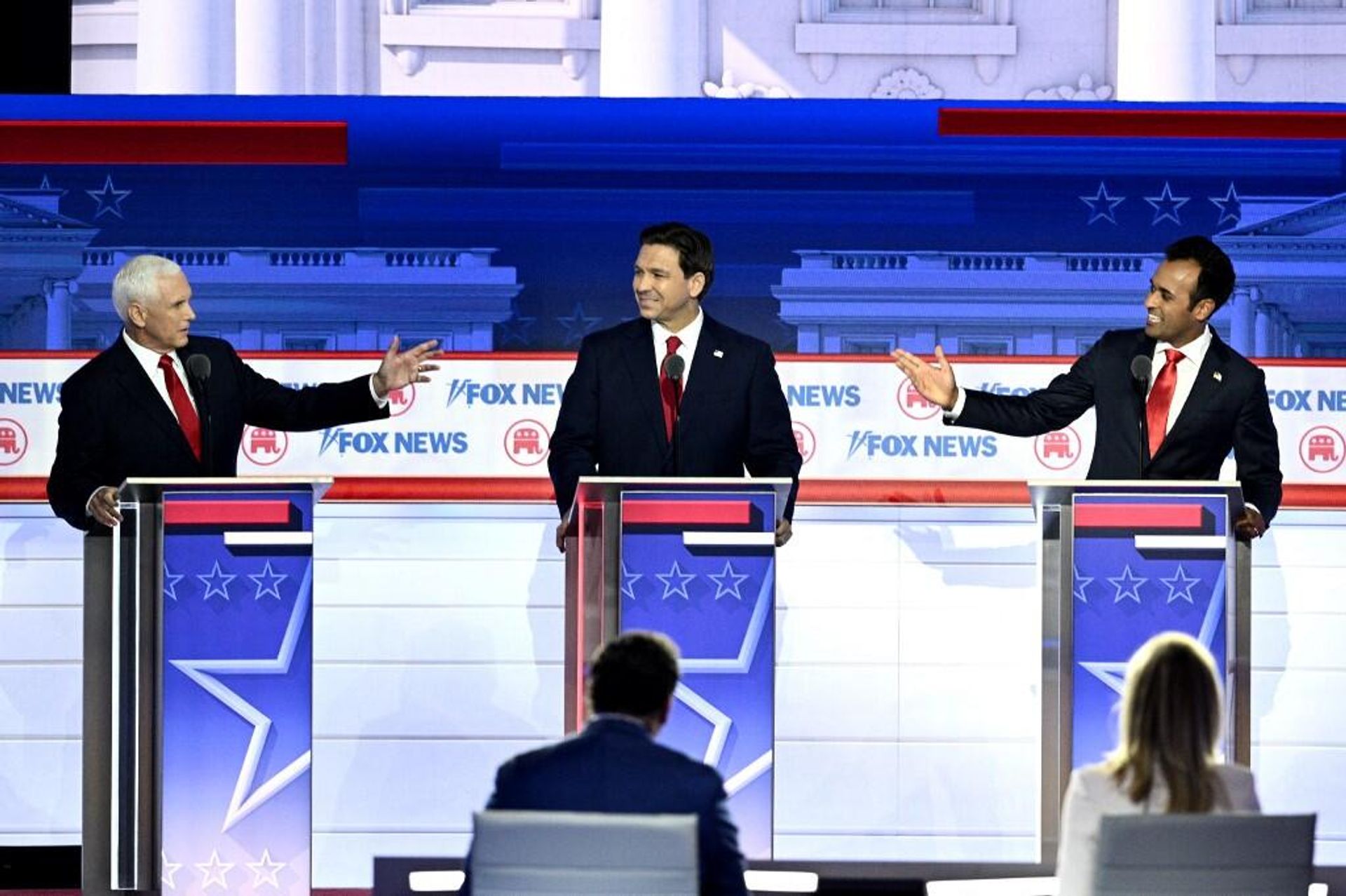 Former US Vice President Mike Pence (L) and entrepreneur and author Vivek Ramaswamy (R) gesture toward Florida Governor Ron DeSantis during the first Republican Presidential primary debate at the Fiserv Forum in Milwaukee, Wisconsin, on August 23, 2023. Former US Vice President Mike Pence (L) and entrepreneur and author Vivek Ramaswamy (R) gesture toward Florida Governor Ron DeSantis during the first Republican Presidential primary debate at the Fiserv Forum in Milwaukee, Wisconsin, on August 23, 2023. - Sputnik International, 1920, 24.08.2023
