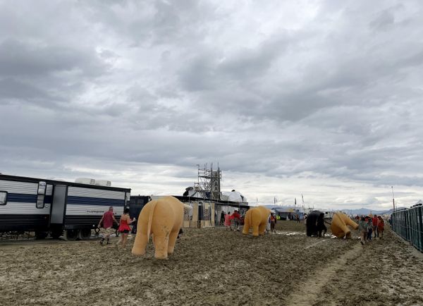 Attendees walk through a muddy desert plain on September 2, 2023, after rains turned the annual Burning Man festival site in Nevada’s Black Rock desert into a treacherous muddy quagmire. (Photo by Julie JAMMOT / AFP) - Sputnik International