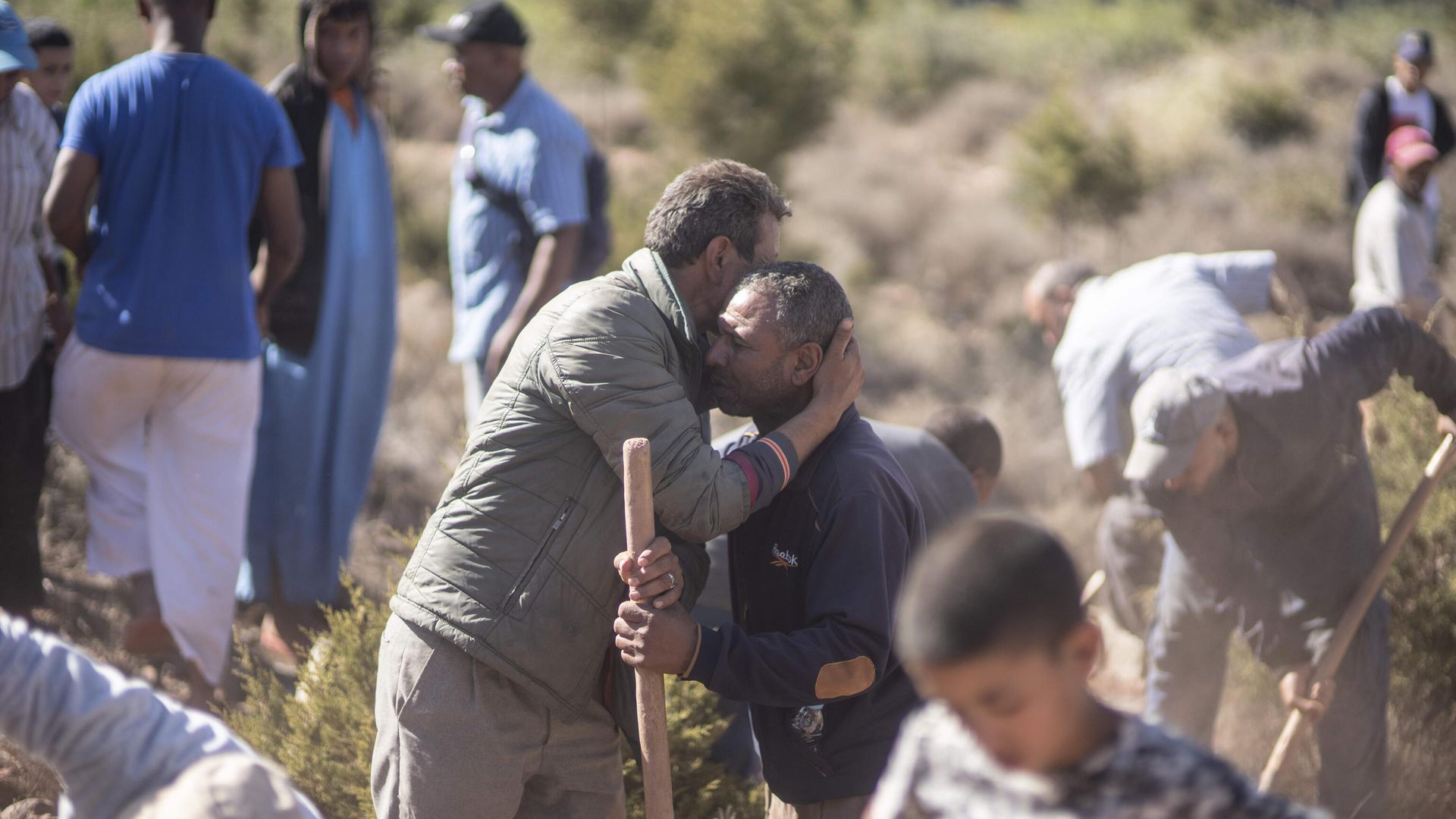 People comfort each other while digging graves for victims of the earthquake, in Ouargane village, near Marrakech, Morocco, Saturday, Sept. 9, 2023. A rare, powerful earthquake struck Morocco, sending people racing from their beds into the streets and toppling buildings in mountainous villages and ancient cities not built to withstand such force.  - Sputnik International, 1920, 09.09.2023