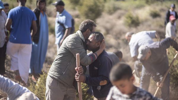 People comfort each other while digging graves for victims of the earthquake, in Ouargane village, near Marrakech, Morocco, Saturday, Sept. 9, 2023. A rare, powerful earthquake struck Morocco, sending people racing from their beds into the streets and toppling buildings in mountainous villages and ancient cities not built to withstand such force.  - Sputnik International