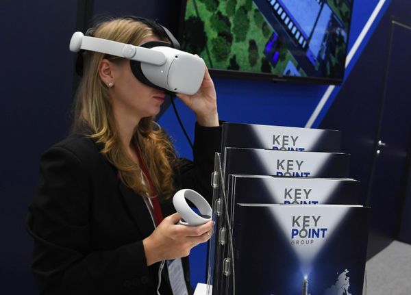 A participant adores a VR helmet which allows people to complete immerse in virtual reality. - Sputnik International