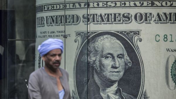 A man walks past a currency exchange shop displaying a giant US dollars banknote in downtown Cairo on November 3, 2016 - Sputnik International