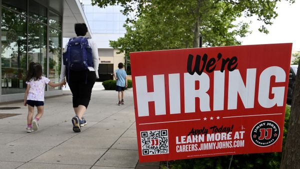 People walk past a now hiring sign posted outside of a restaurant in Arlington, Virginia on June 3, 2022.  - Sputnik International