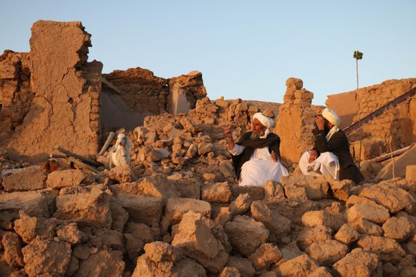 Afghan residents sit at a house damaged by the natural disaster. - Sputnik International