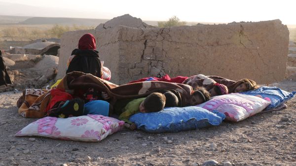 Afghan children rest under a blanket beside damaged houses in Sarbuland village of Zendeh Jan district of Herat province. - Sputnik International