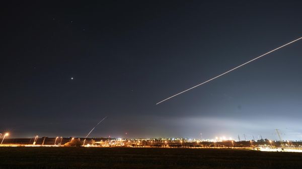 Israel's Iron Dome anti-missile system fires to intercept a rocket launched from the Gaza Strip towards Israel, near Sderot - Sputnik International